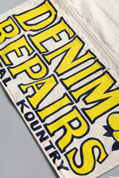 Kapital 2023 Spring Summer advertising apron with a vintage-like logo 3 pockets with different sizes. Featured on the apron is yellow Novelty typography. 13oz distressed denim. Color: Ecru 100% Cotton Made in Japan. 