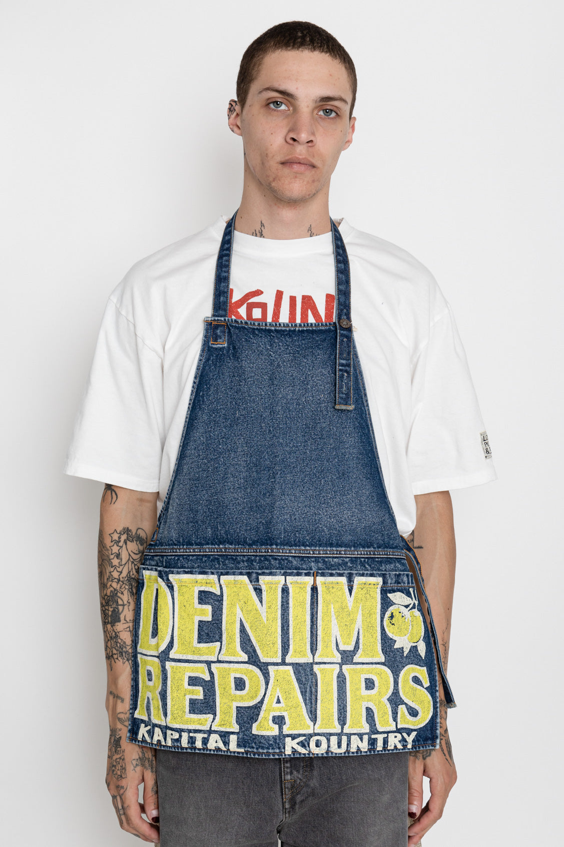 Kapital 2023 Spring Summer advertising apron with a vintage-like logo 3 pockets with different sizes. Featured on the apron is yellow Novelty typography. 13oz distressed denim. Color: Yellow 100% Cotton Made in Japan. 