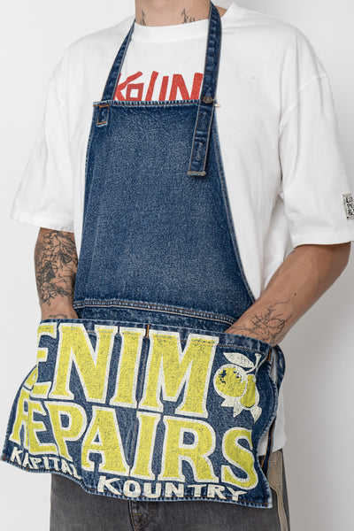 Kapital 2023 Spring Summer advertising apron with a vintage-like logo 3 pockets with different sizes. Featured on the apron is yellow Novelty typography. 13oz distressed denim. Color: Yellow 100% Cotton Made in Japan. 