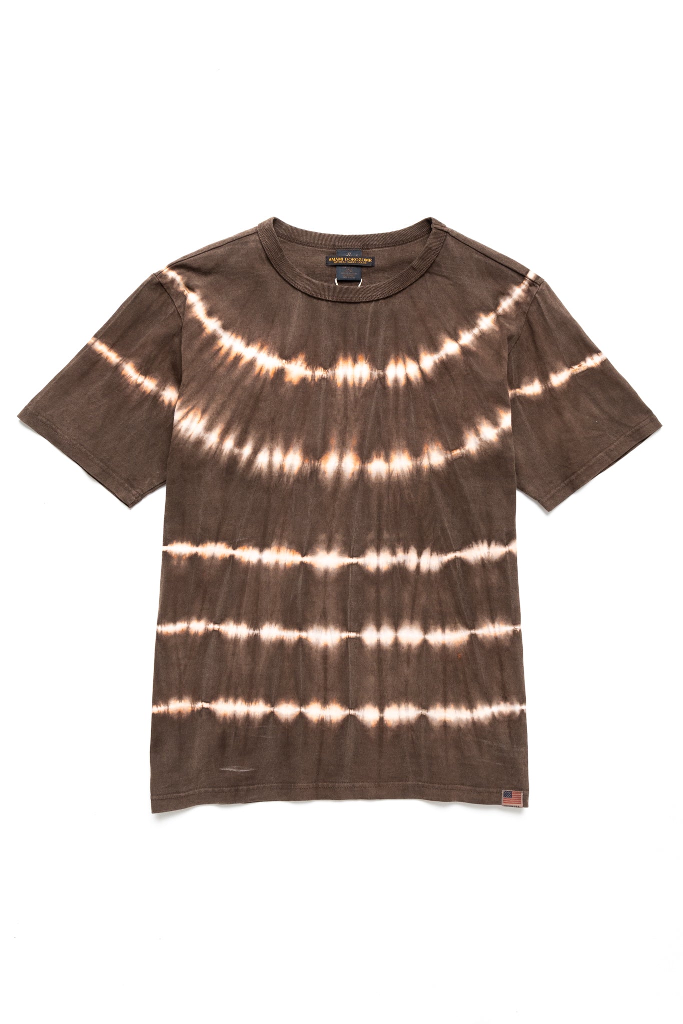 Studio D'Artisan hand dyed t-shirt.The ancient dyeing method, Amami Mud Dyeing, has a gentle, deep, powerful, and astringent color that cannot be synthesized with chemical dyes. 100% cotton. Made In Japan 