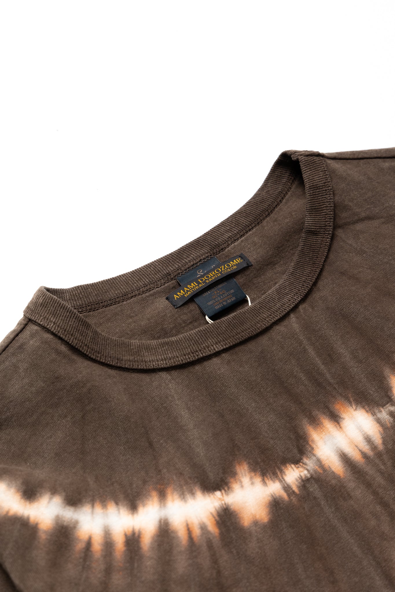 Studio D'Artisan hand dyed t-shirt.The ancient dyeing method, Amami Mud Dyeing, has a gentle, deep, powerful, and astringent color that cannot be synthesized with chemical dyes. 100% cotton. Made In Japan 
