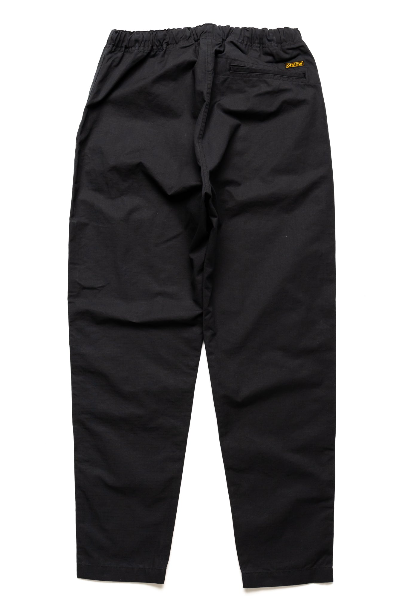Orslow's easy to wear trousers with an elastic waist and cord drawstring made in Japan. 100% cotton ripstop fabric. Straight leg with a slight taper that features two front pockets and one back. 