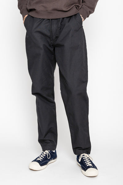 Orslow's easy to wear trousers with an elastic waist and cord drawstring made in Japan. 100% cotton ripstop fabric. Straight leg with a slight taper that features two front pockets and one back. 