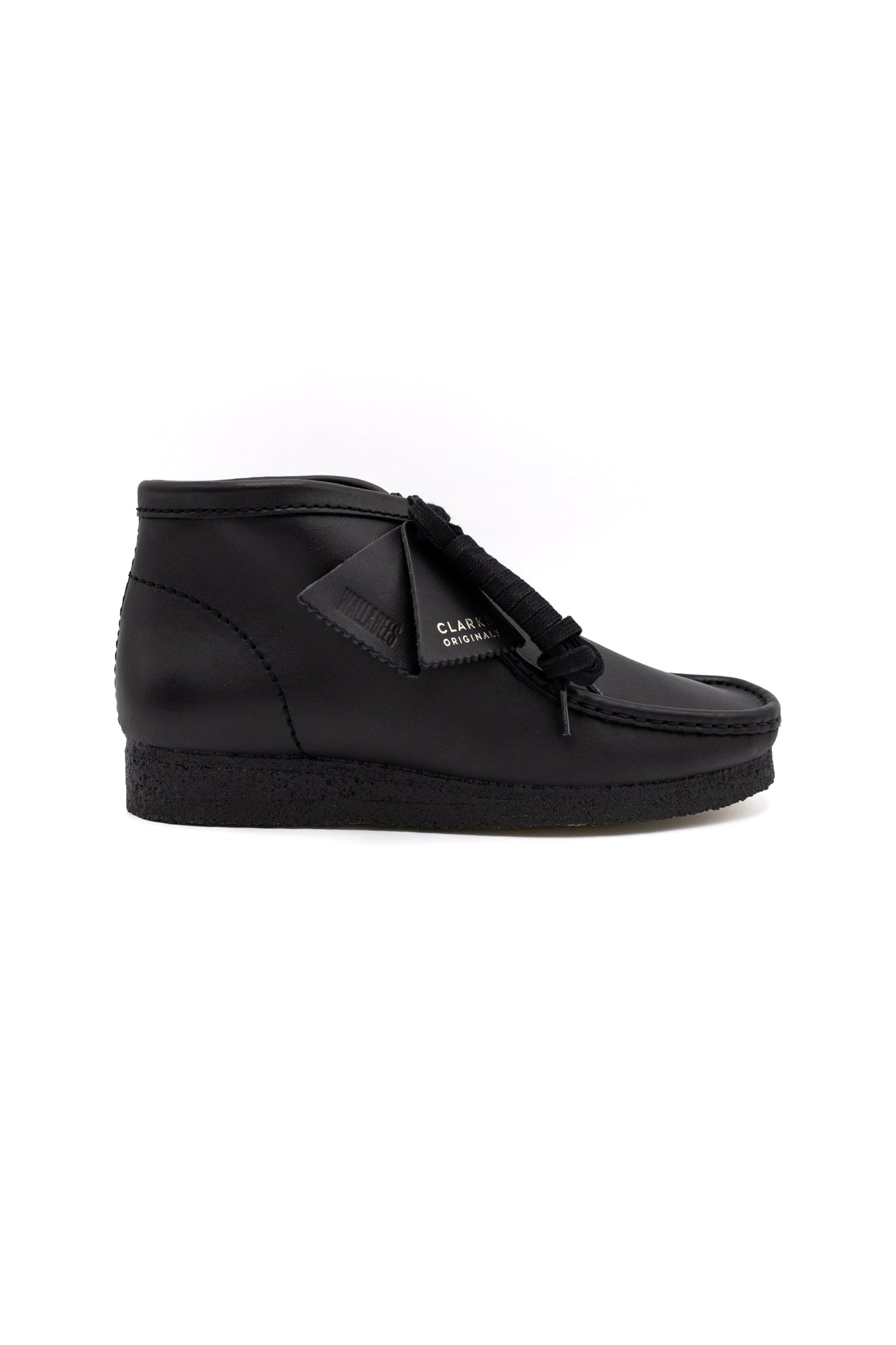 Clark's Original Wallaby Boot in Black Leather. With rugged leather uppers for a premium feel, this silhouette sits atop a chunky pebble crepe sole to stay true to its design DNA, while waxy laces and tonal fobs complete this stone cold classic. Premium black leather upper Natural rubber pebble crepe sole Finished with two Clarks Originals fobs