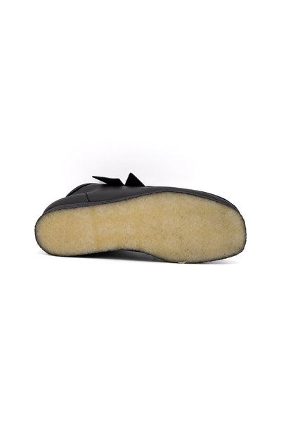 Clark's Original Wallaby Boot in Black Leather. With rugged leather uppers for a premium feel, this silhouette sits atop a chunky pebble crepe sole to stay true to its design DNA, while waxy laces and tonal fobs complete this stone cold classic. Premium black leather upper Natural rubber pebble crepe sole Finished with two Clarks Originals fobs
