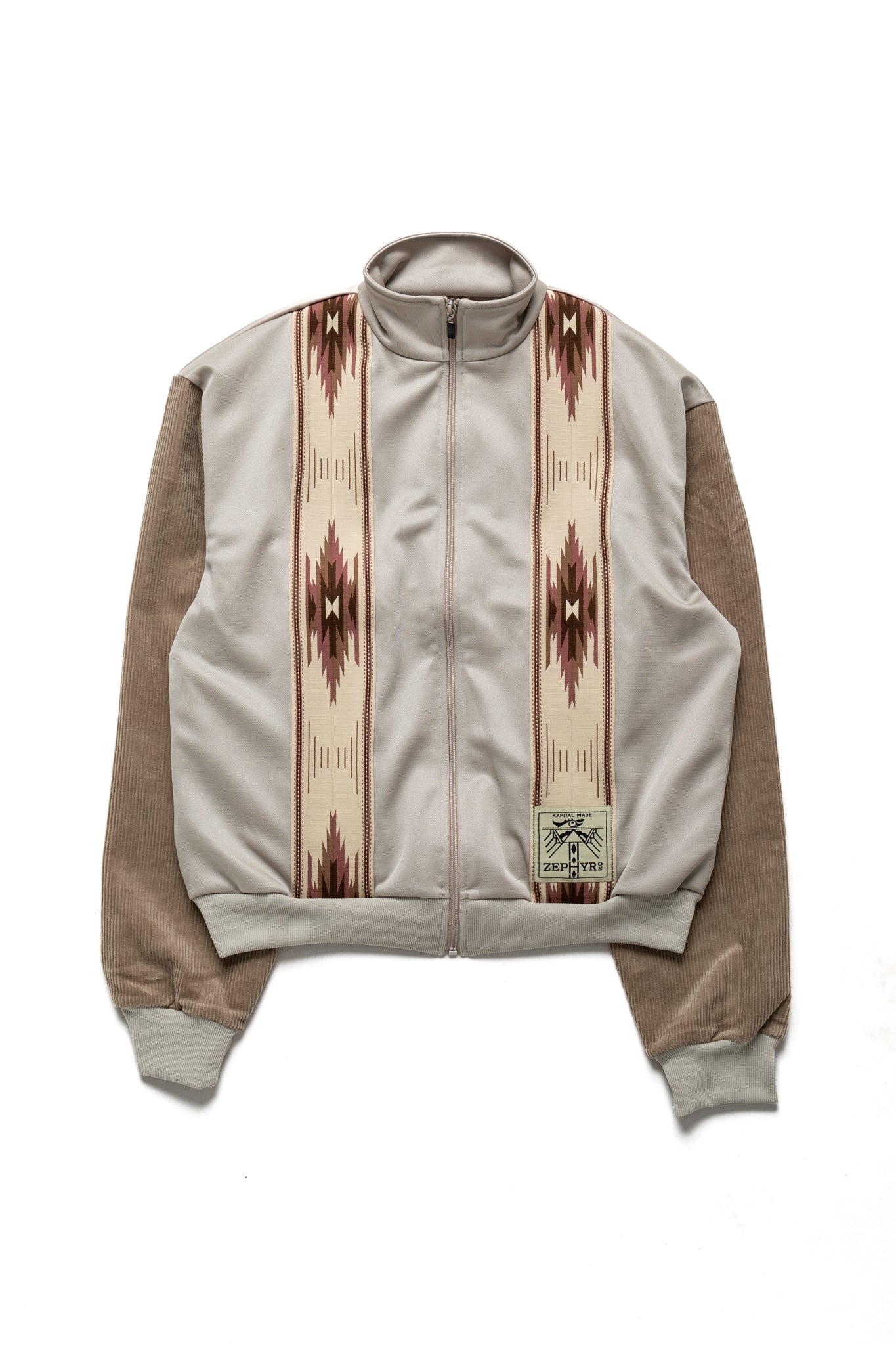 Kapital Beige trucker jacket with an eye -catching Ortega pattern front line. The sleeves are stitched with corduroy fabric in the middle ridge. 100% polyester Sleeve parts: 98% cotton, 2% polyurethane Made in Japan 