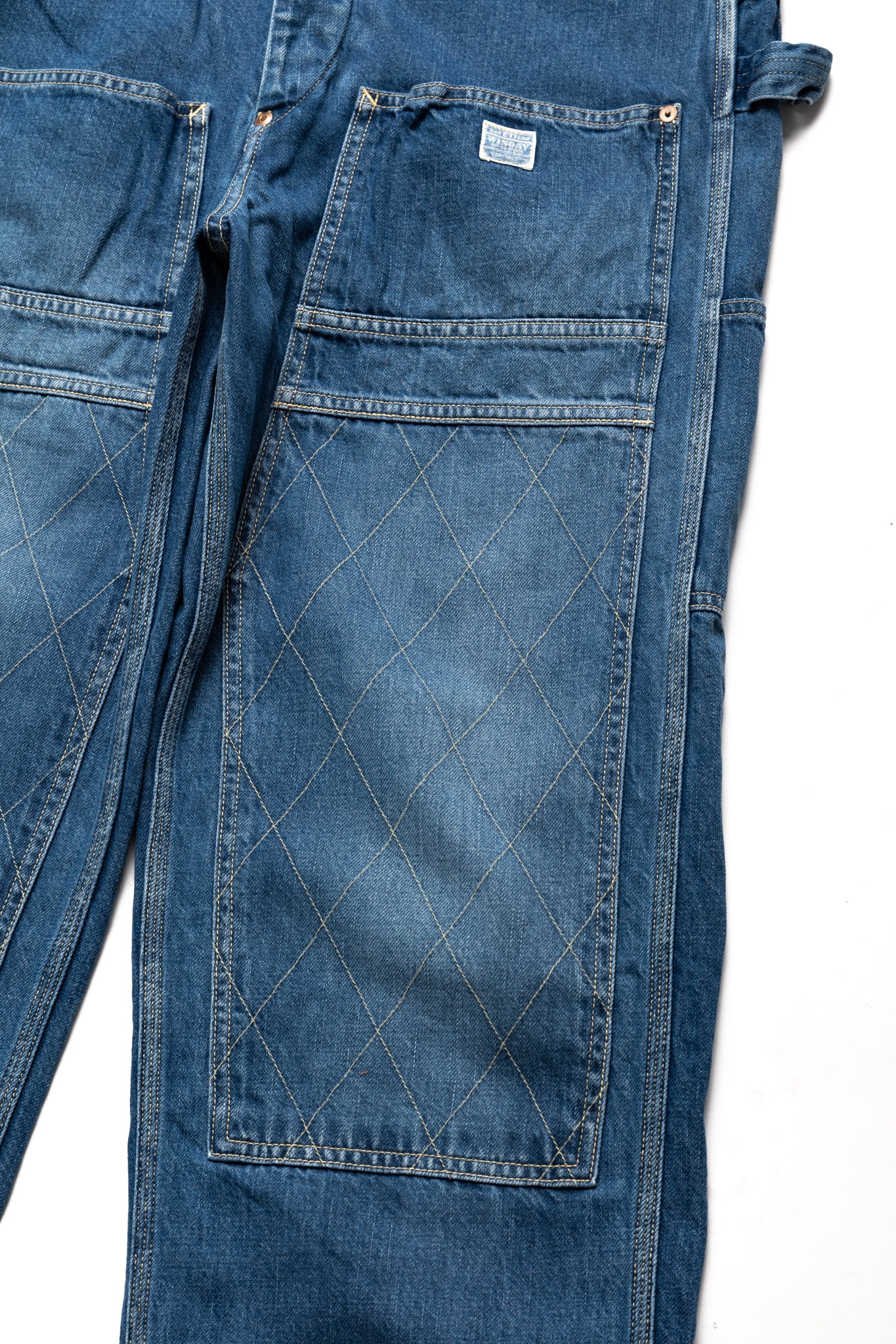 Kapital loose fitting pants inspired by overalls. A number of pockets are in various places, replicating cargos and overalls. Intentional distressing. Color:Faded indigo. 100% Cotton Made in Japan 