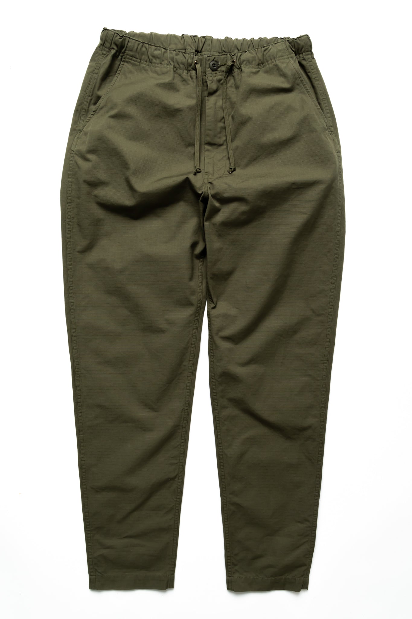 Easy to wear Orslow trousers with an elastic waist and cord drawstring made in Japanese 100% cotton ripstop fabric. Straight leg with a slight taper that features two front pockets and one back. Color: Army Green. Fabric: 100% Cotton. Unisex. Made in Japan.